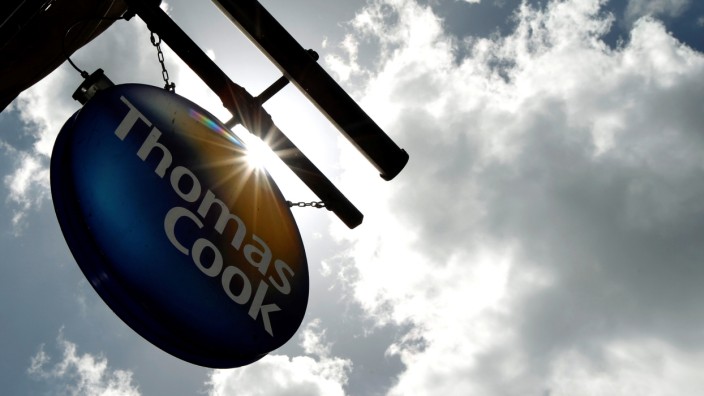 FILE PHOTO: A sign hangs in front of a branch of travel agent Thomas Cook in London