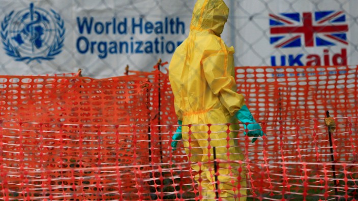 FILE PHOTO: A person dressed in ebola protective apparel is seen inside an ebola care facility at the Bwera general hospital near the border with the Democratic Republic of Congo in Bwera