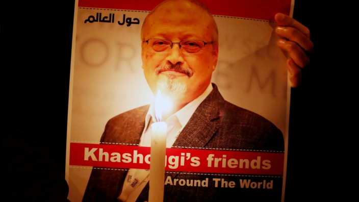 FILE PHOTO: A demonstrator holds a poster with a picture of Saudi journalist Jamal Khashoggi outside the Saudi Arabia consulate in Istanbul