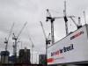 FILE PHOTO: An electronic billboard displaying a British government Brexit information awareness campaign advertisement is seen near construction cranes in London, Britain