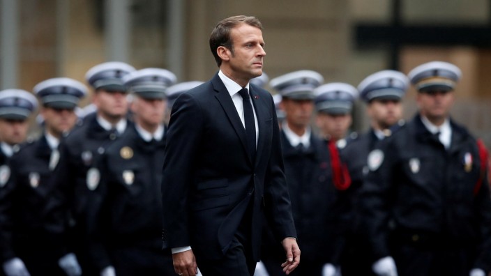 French President Emmanuel Macron attends a ceremony to honour four victims of Paris police attack