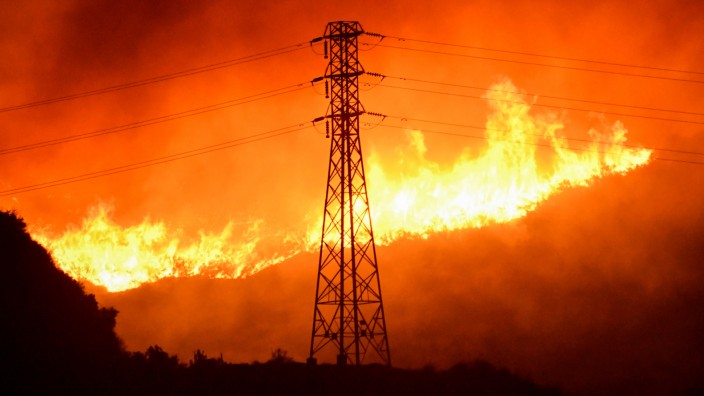 Firefighters battle a wind-driven wildfire in Sylmar, California