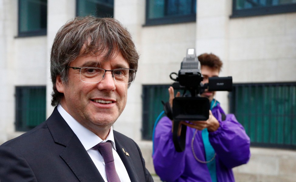 Former Catalan leader Carles Puigdemont leaves free a prosecutor office at the Justice Palace after handing himself to police in Brussels