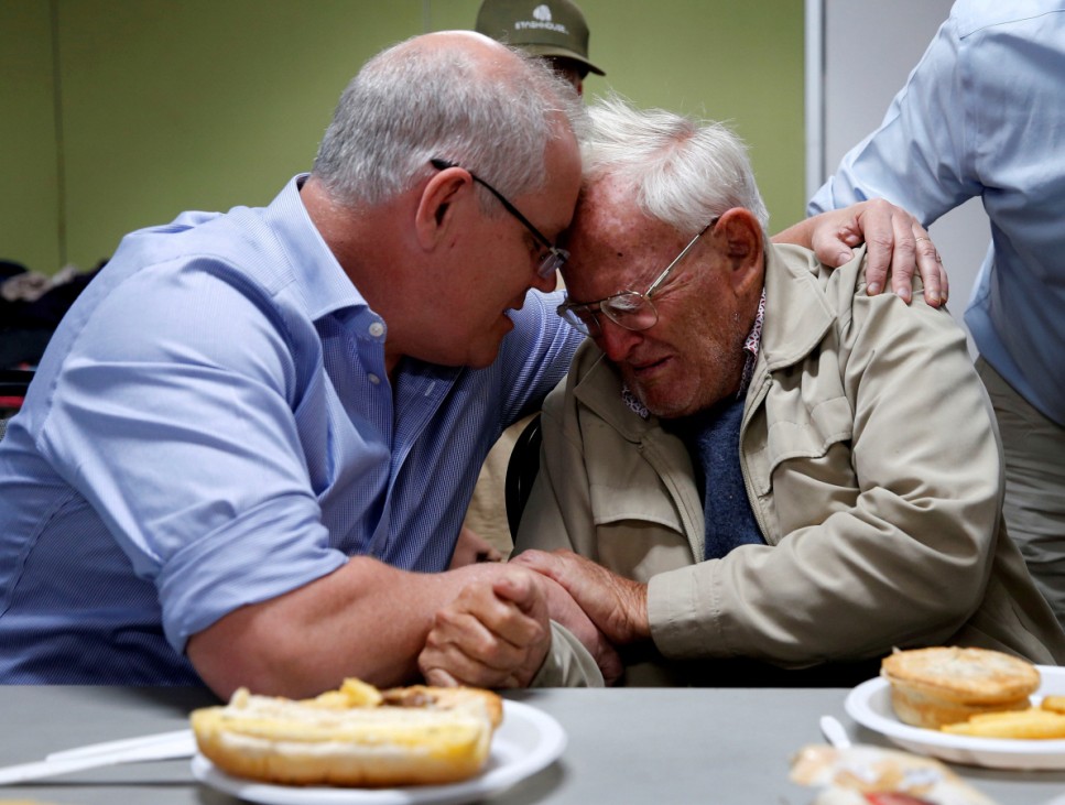Australia's Prime Minister Scott Morrison comforts 85-year-old evacuee Owen Whalan during a visit to Club Taree Evacuation Centre in Taree
