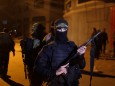 Palestinian Islamic Jihad militant stands guard at the scene of an Israeli strike that killed the group's field commander Baha Abu Al-Atta in Gaza City