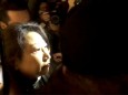 Hong Kong Justice Secretary Teresa Cheng walks as protesters surround her in London, Britain