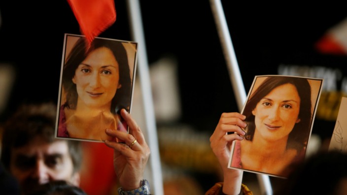 People carry photos of assassinated anti-corruption journalist Daphne Caruana Galizia during an anti-corruption protest against the government of Prime Minister Joseph Muscat, in Valletta