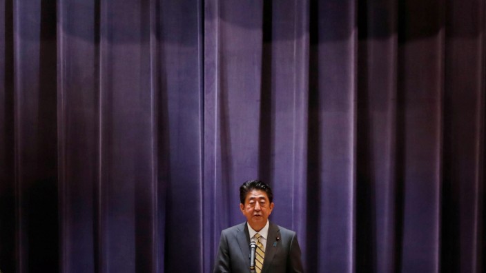 Japan's PM Abe addresses Japan's Self-Defense Forces senior members during a meeting at the Defense Ministry in Tokyo