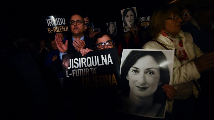 People gather outside the Maltese Prime Minister's office calling for the resignation of Joseph Muscat, in Valletta