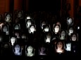 FILE PHOTO: People hold up photos of anti-corruption journalist Daphne Caruana Galizia during a protest marking eighteen months since her assassination, outside the office of Prime Minister Muscat in Valletta