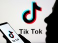 FILE PHOTO: Person holds a smartphone with Tik Tok logo displayed in this picture illustration