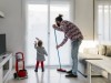 Father and little daughter cleaning the living room together model released Symbolfoto property rele