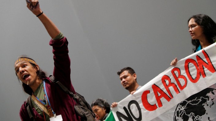 An activist speaks during a protest about the destruction brought by carbon markets and carbon offsets inside the venue of the U.N. climate change conference (COP25) in Madrid