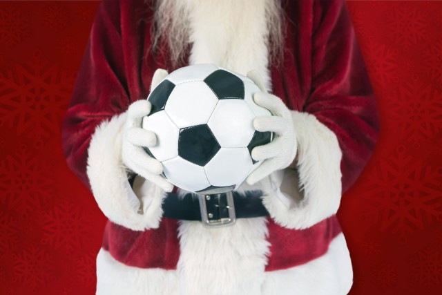 Composite image of santa holds a classic football model released Symbolfoto PUBLICATIONxINxGERxSUIx
