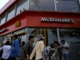 FILE PHOTO: People walk past McDonald's fast-food restaurant in Lima