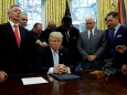 FILE PHOTO: Faith leaders place their hands on the shoulders of U.S. President Trump as he takes part in a prayer for those affected by Hurricane Harvey in the Oval Office of the White House in Washington