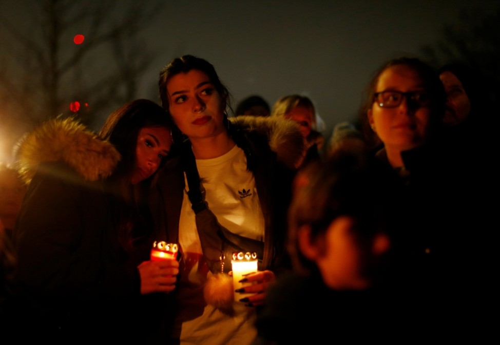 People mourn outside the zoo of Krefeld after a monkey house burned down
