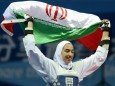 (140820) -- NANJING, Aug. 20, 2014 -- Kimia Alizadeh Zenoorin of Iran celebrates with holding her national flag after w