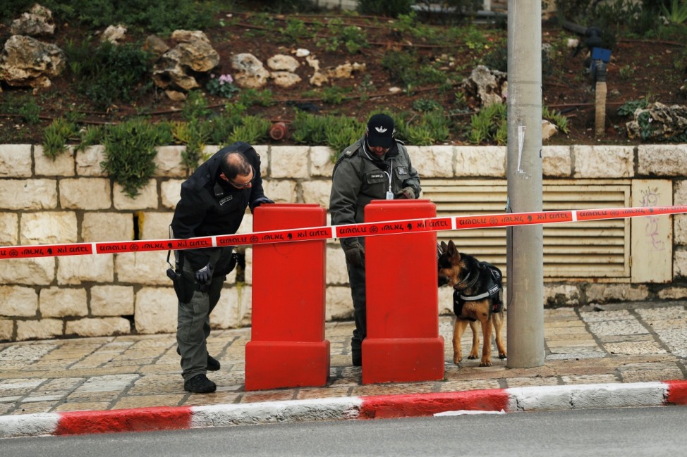 Israeli policemen and a police dog patrol the area as the city gears up to host a Holocaust memorial event at Yad Vashem, in Jerusalem