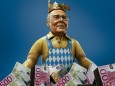 A papier mache caricature depicting former international Beckenbauer is pictured during preparations for the upcoming Rose Monday carnival parade in Mainz; Collage WM 2006