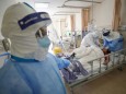Medical workers in protective suits attend to a patient inside an isolated ward of Wuhan Red Cross Hospital in Wuhan, the epicentre of the novel coronavirus outbreak