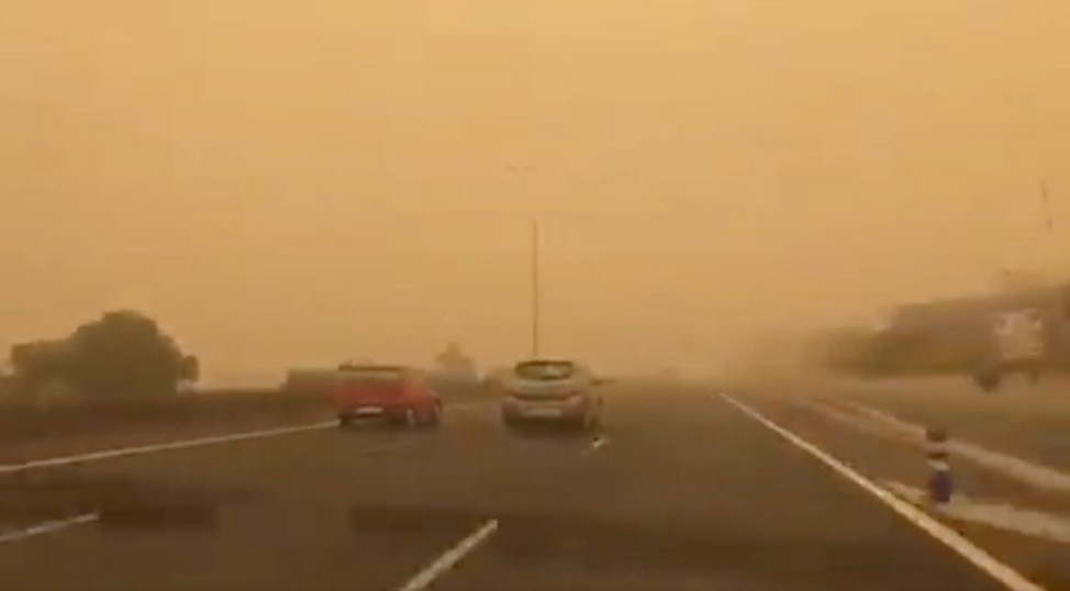 Cars drive through a sandstorm blown over from North Africa known as 'calima' at Gran Canaria