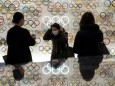 People wearing protective face masks, following an outbreak of the coronavirus, are seen at The Japan Olympics museum in Tokyo