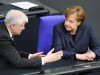 German Chancellor Angela Merkel and Interior Minister Horst Seehofer attend a plenum session at the lower house of parliament, Bundestag, in Berlin