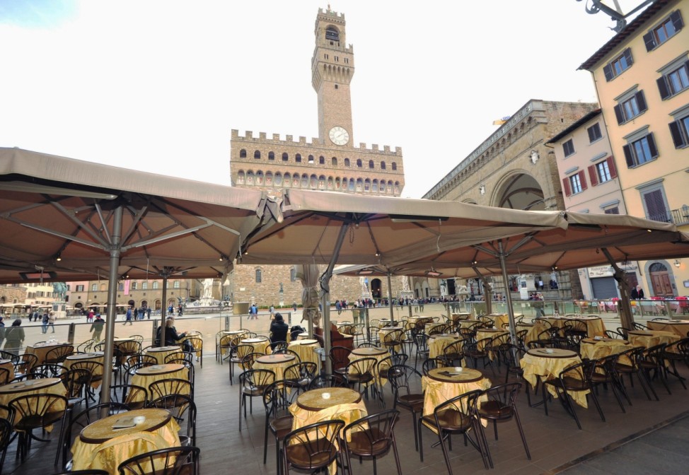 Empty tables are pictured outside a restaurant at Palazzo Vecchio as Italy battles a coronavirus outbreak, in Florence