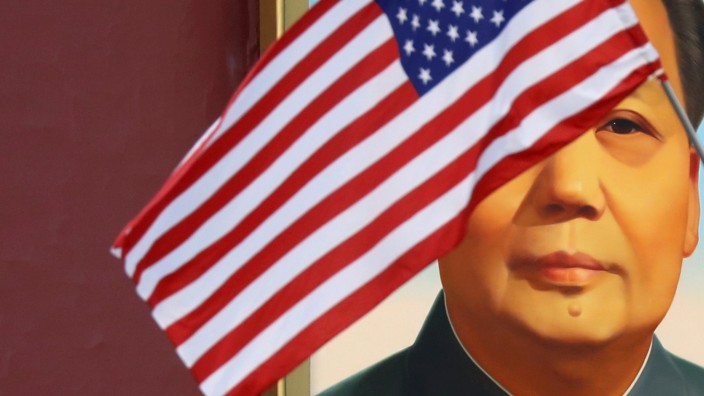 FILE PHOTO: U.S. flag flutters in front of a portrait of late Chinese Chairman Mao at Tiananmen gate during the visit by U.S. President Trump to Beijing