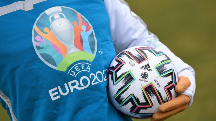 UEFA Euro 2020 mascot Skillzy poses for a photo with the official match ball at Olympiapark in Munich