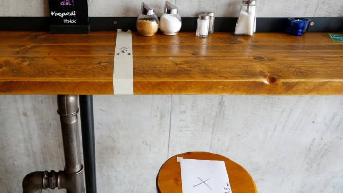 Instructions to keep 1,5 metres of distance between restaurants guests are seen at a burger restaurant  in Berlin