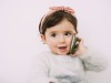 Portrait of smiling baby girl looking at cell phone model released Symbolfoto PUBLICATIONxINxGERxSUI