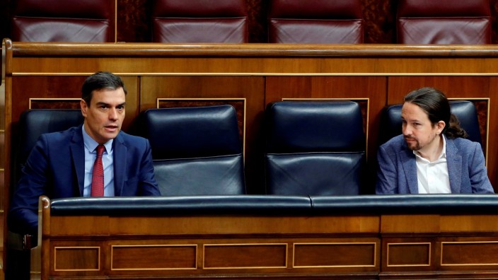 Spanish PM Sanchez paand second deputy PM Iglesias talk keeping social distancing during a session on coronavirus disease (COVID-19) at Parliament in Madrid