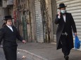 An Ultra-Orthodox Jew wears a mask, as protection from the coronavirus, while shopping for the Jewish holiday Passover,