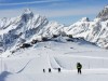 Skiers skiing on a ski run mountain scenery in Cervinia ski resort Cervinia Valle d Aosta Italia