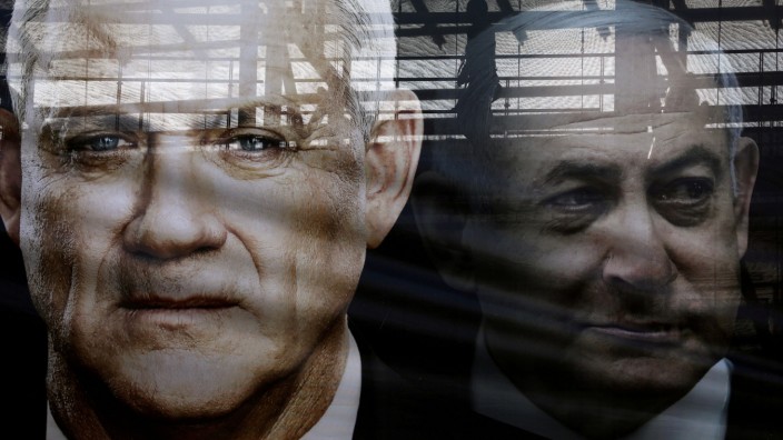 FILE PHOTO: A banner depicts Benny Gantz, leader of Blue and White party, and Israel Prime minister Benjamin Netanyahu, as part of Blue and White party's campaign ahead of the upcoming election, in Tel Aviv
