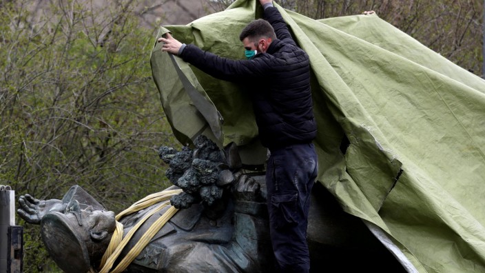 FILE PHOTO: A worker covers the statue of Soviet World War II commander Ivan Stepanovic Konev after removal from its platform in Prague