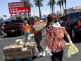 Las Vegas Residents In Need Pick Up Goods At Local Food Bank Drive-Thru Distribution