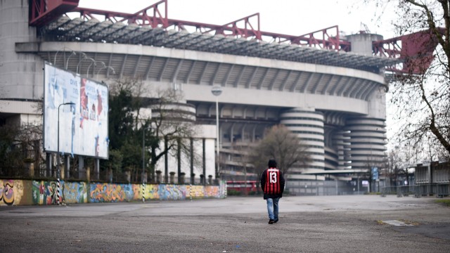 (200303) -- BEIJING, March 3, 2020 -- A fan of AC Milan walks outside the San Siro stadium after a Serie A soccer match; Milan