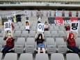 Mannequins are placed in spectator seats to cheer during football match in Seoul