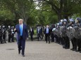 U.S. President Trump walks between lines of riot police in Washington