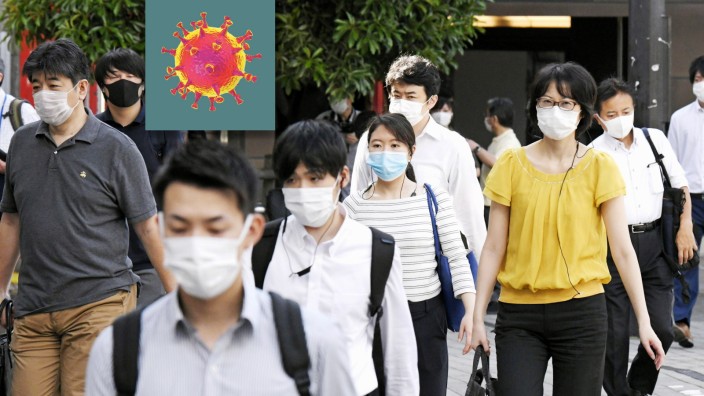 New coronavirus Commuters go to work in Tokyo on June 12, 2020, wearing face masks amid continued worries over the novel