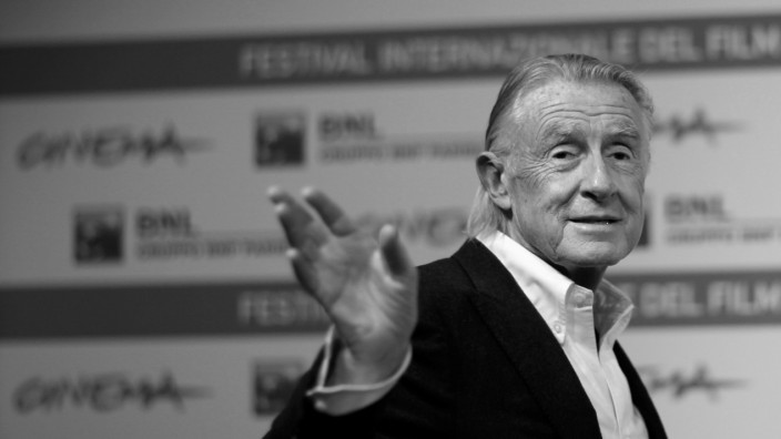 FILE PHOTO: Director Schumacher waves as he poses during a photo call at the International Rome Film Festival; FILE PHOTO: Director Schumacher waves as he poses during a photo call at the International Rome Film Festival