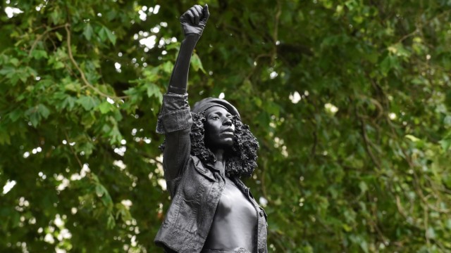 A sculpture of a Black Lives Matter protester stands on the empty plinth previously occupied by the statue of slave trader Edward Colston, in Bristol
