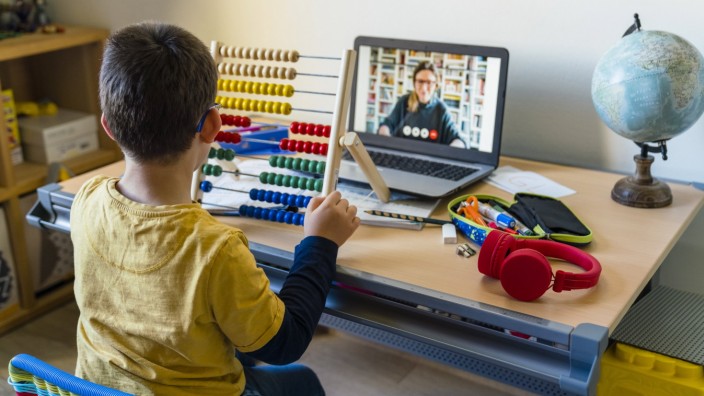 Boy using abacus with teacher on video call during homeschooling model released Symbolfoto property released MGIF00957