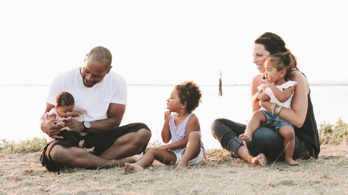 Interracial Family Relaxing On The Beach British Columbia Canada PUBLICATIONxINxGERxSUIxAUTxONLY C