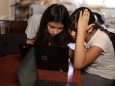 Los Angeles Unified School District (LAUSD) students work on school-issued computers with unreliable internet connectivity, at their home in Los Angeles