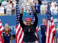 FILE PHOTO: Williams of the U.S. raises her trophy after defeating Wozniacki of Denmark in their women's singles finals match at the 2014 U.S. Open tennis tournament in New York