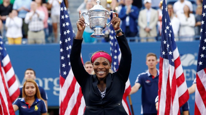 FILE PHOTO: Williams of the U.S. raises her trophy after defeating Wozniacki of Denmark in their women's singles finals match at the 2014 U.S. Open tennis tournament in New York